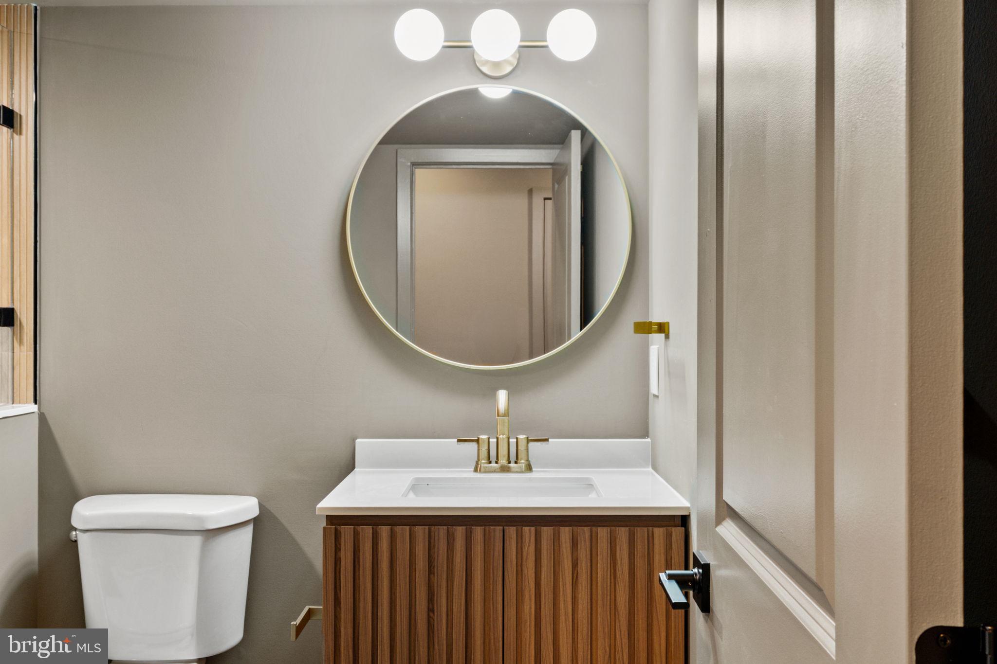 2410 Nicholas Street Philadelphia, PA 19121 - Photo 27 of 55 a bathroom with a sink a mirror and a toilet