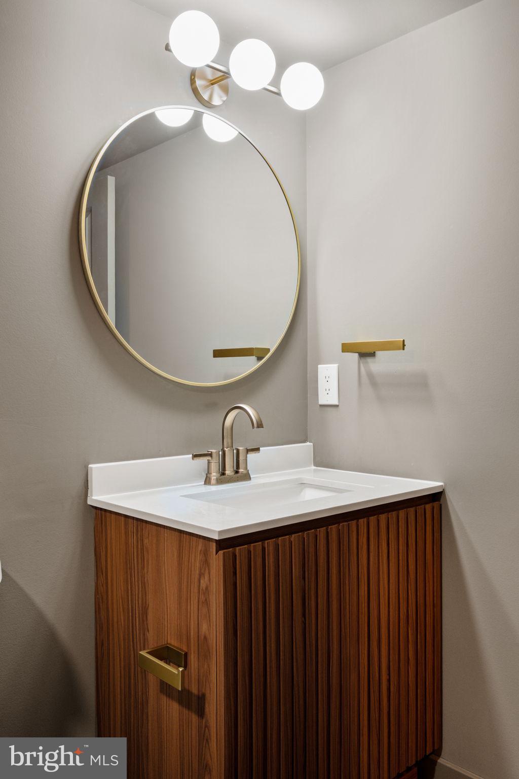 2410 Nicholas Street Philadelphia, PA 19121 - Photo 29 of 55 a bathroom with a sink vanity and a mirror