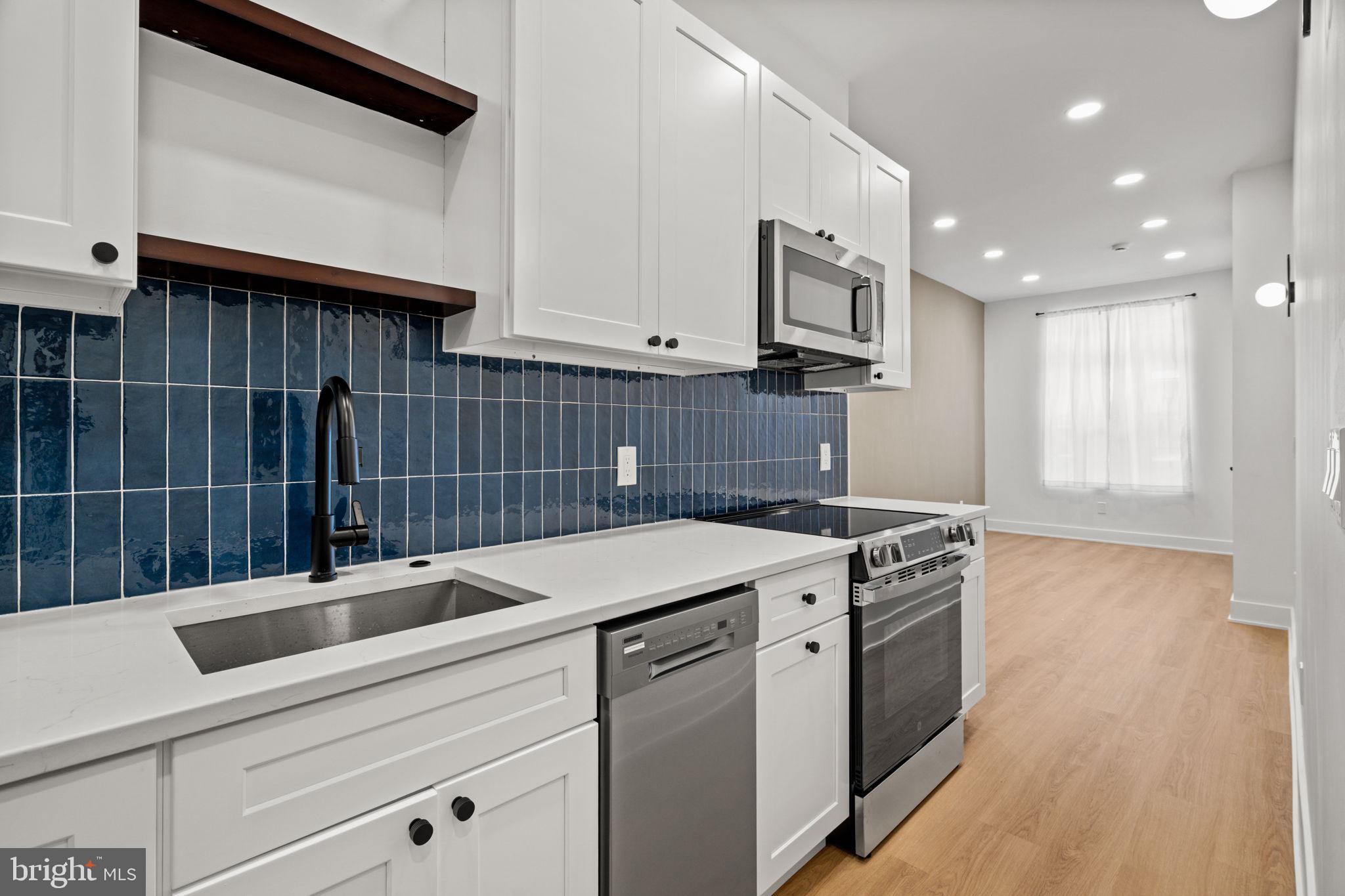 2410 Nicholas Street Philadelphia, PA 19121 - Photo 37 of 55 a kitchen that has a sink and a stove in it