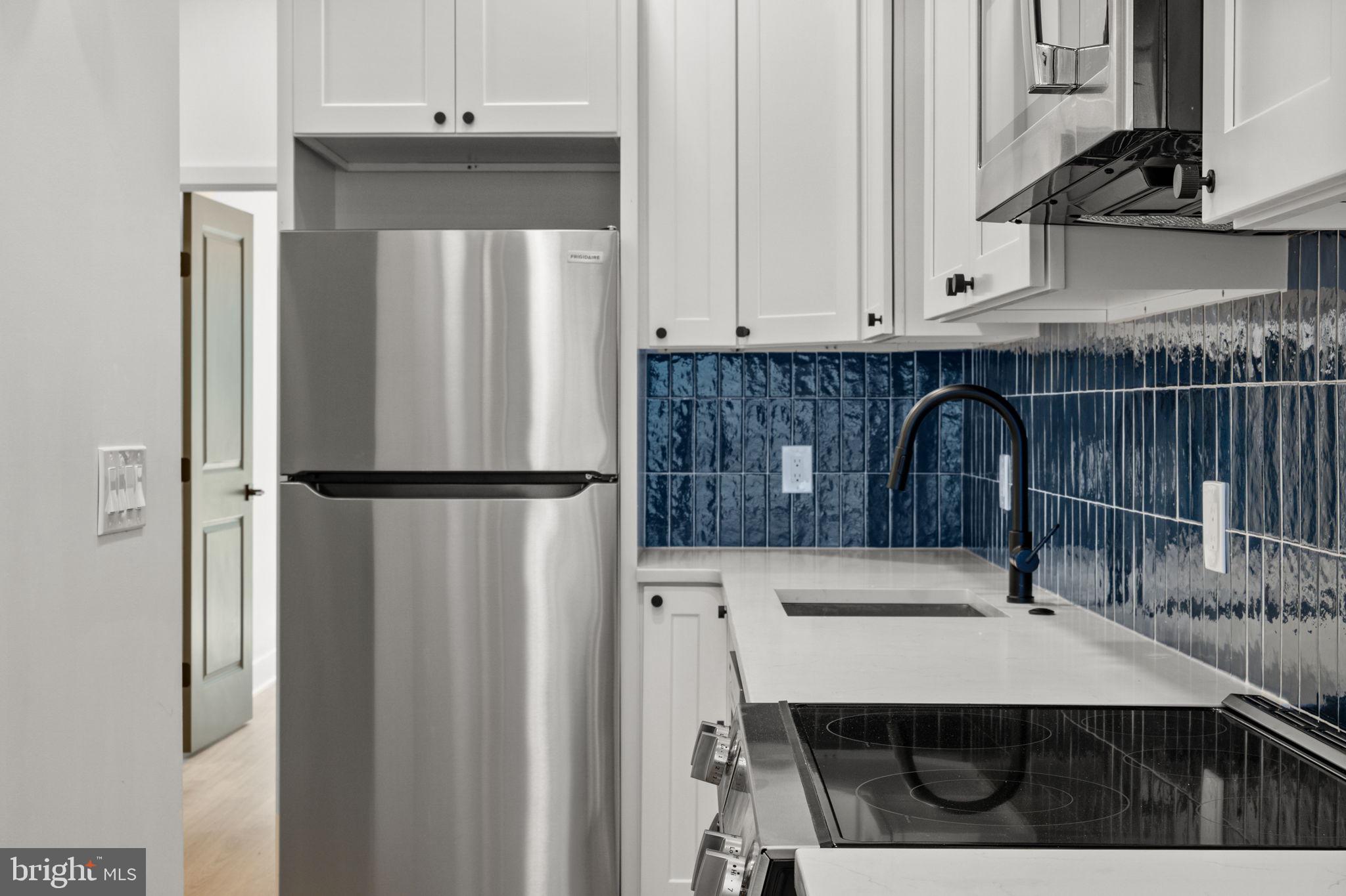 2410 Nicholas Street Philadelphia, PA 19121 - Photo 40 of 55 a kitchen with a refrigerator and cabinets