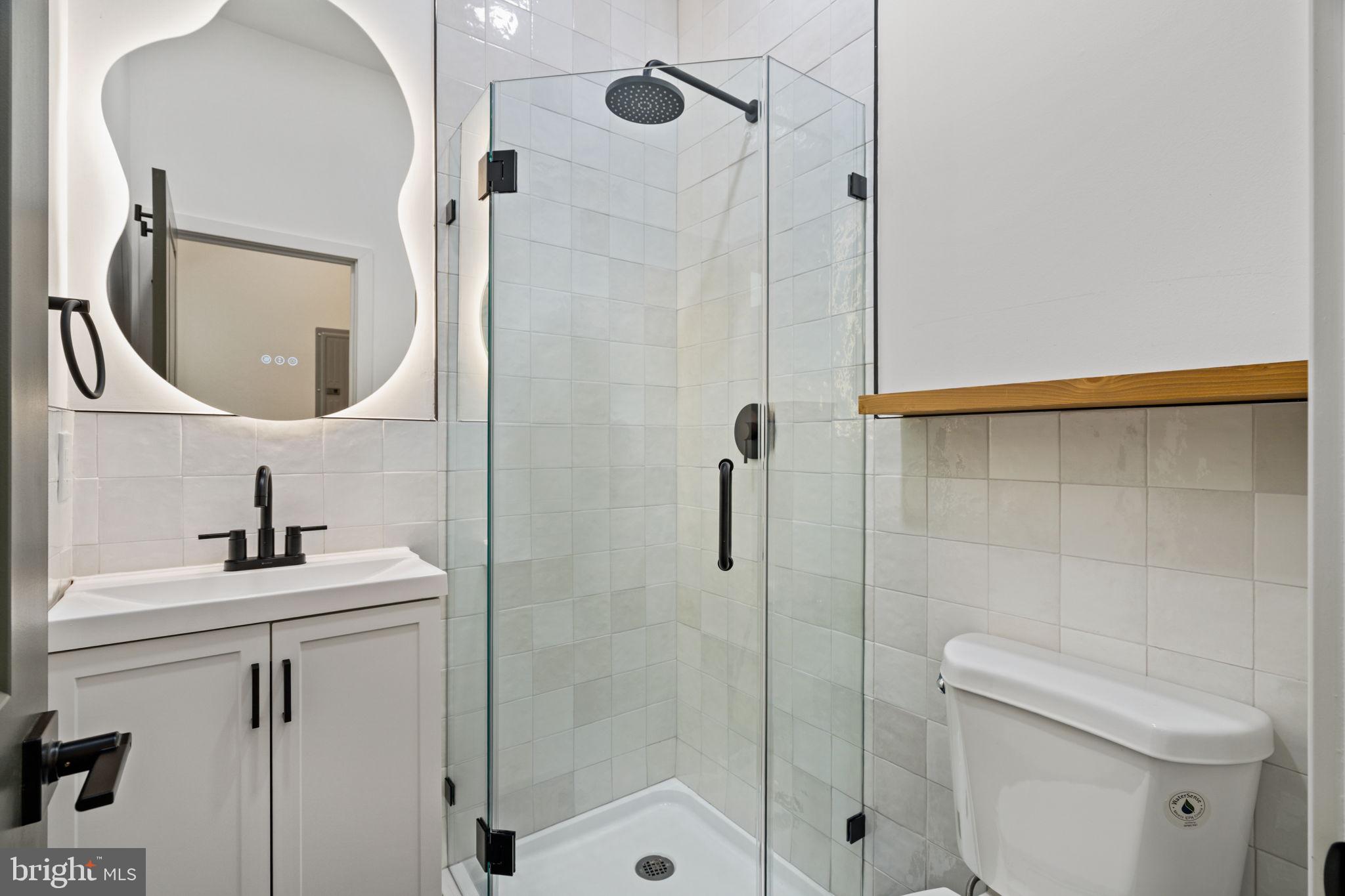2410 Nicholas Street Philadelphia, PA 19121 - Photo 42 of 55 a bathroom with a sink a toilet and shower
