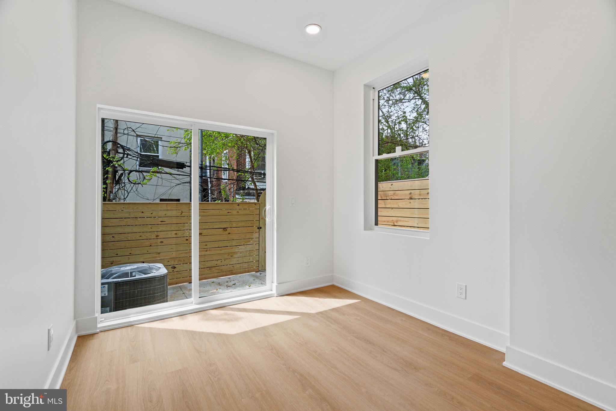 2410 Nicholas Street Philadelphia, PA 19121 - Photo 45 of 55 an empty room with wooden floor and windows