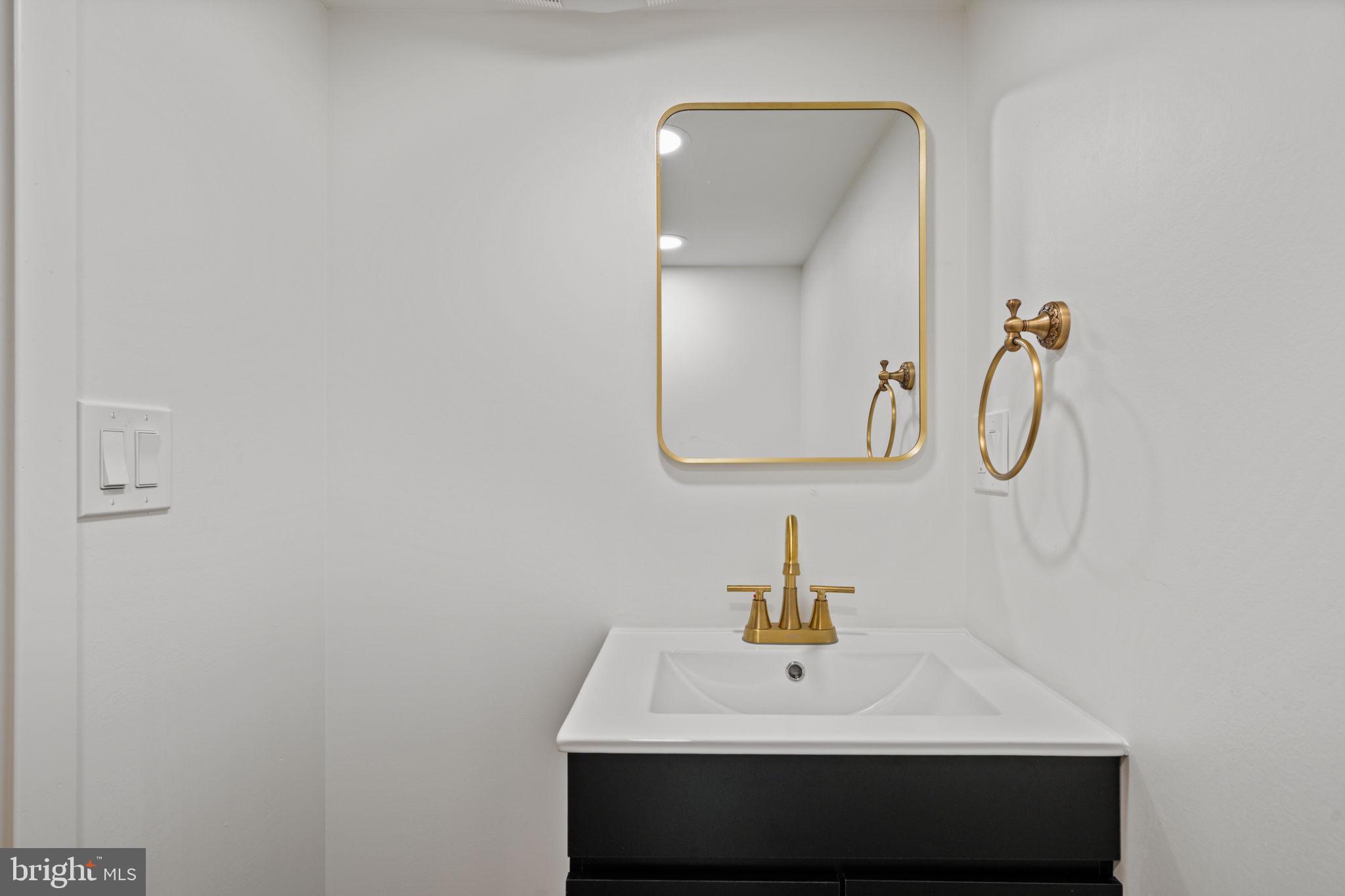 2410 Nicholas Street Philadelphia, PA 19121 - Photo 53 of 55 a bathroom with a sink and a mirror