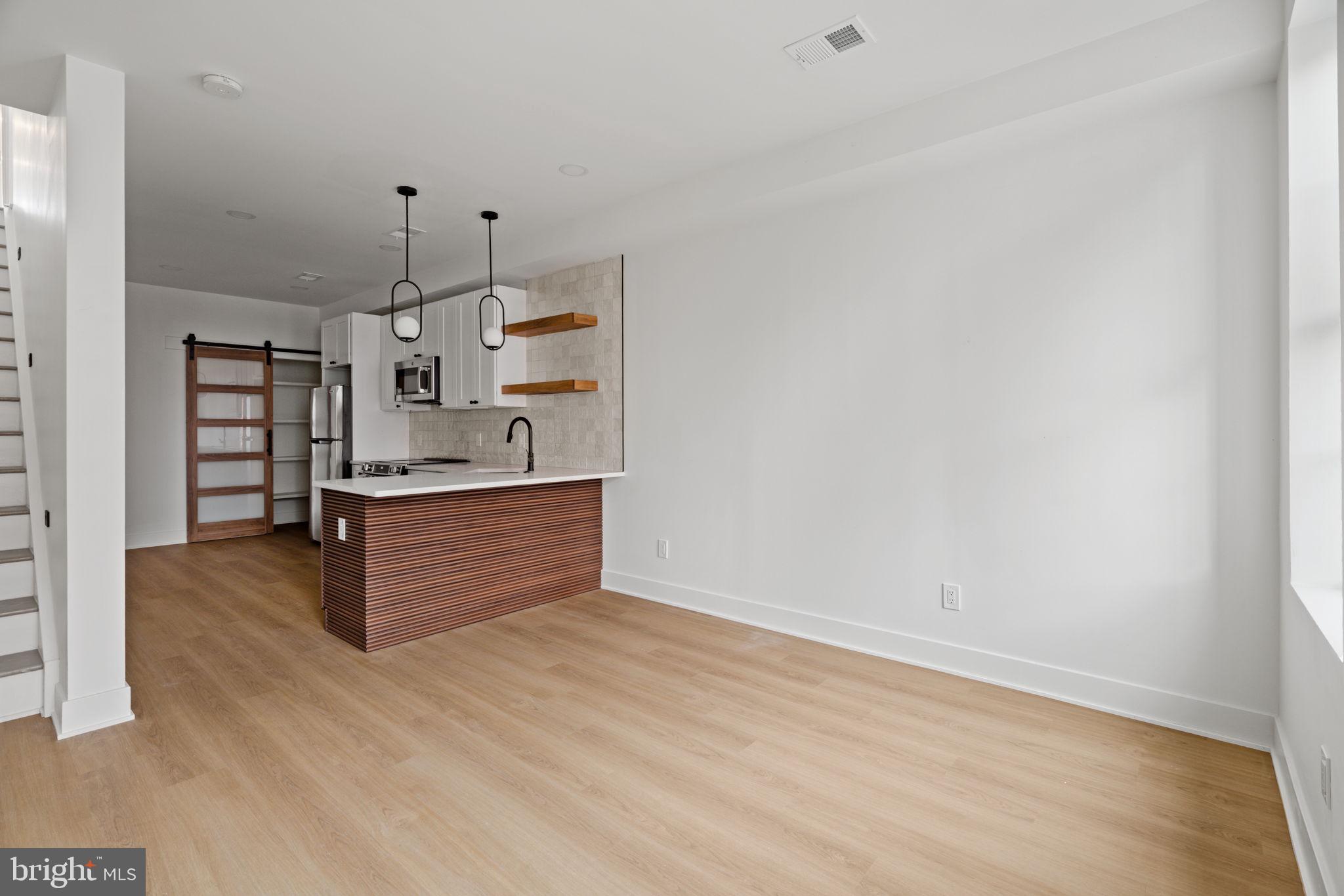 2410 Nicholas Street Philadelphia, PA 19121 - Photo 8 of 55 a kitchen with stainless steel appliances a refrigerator and cabinets