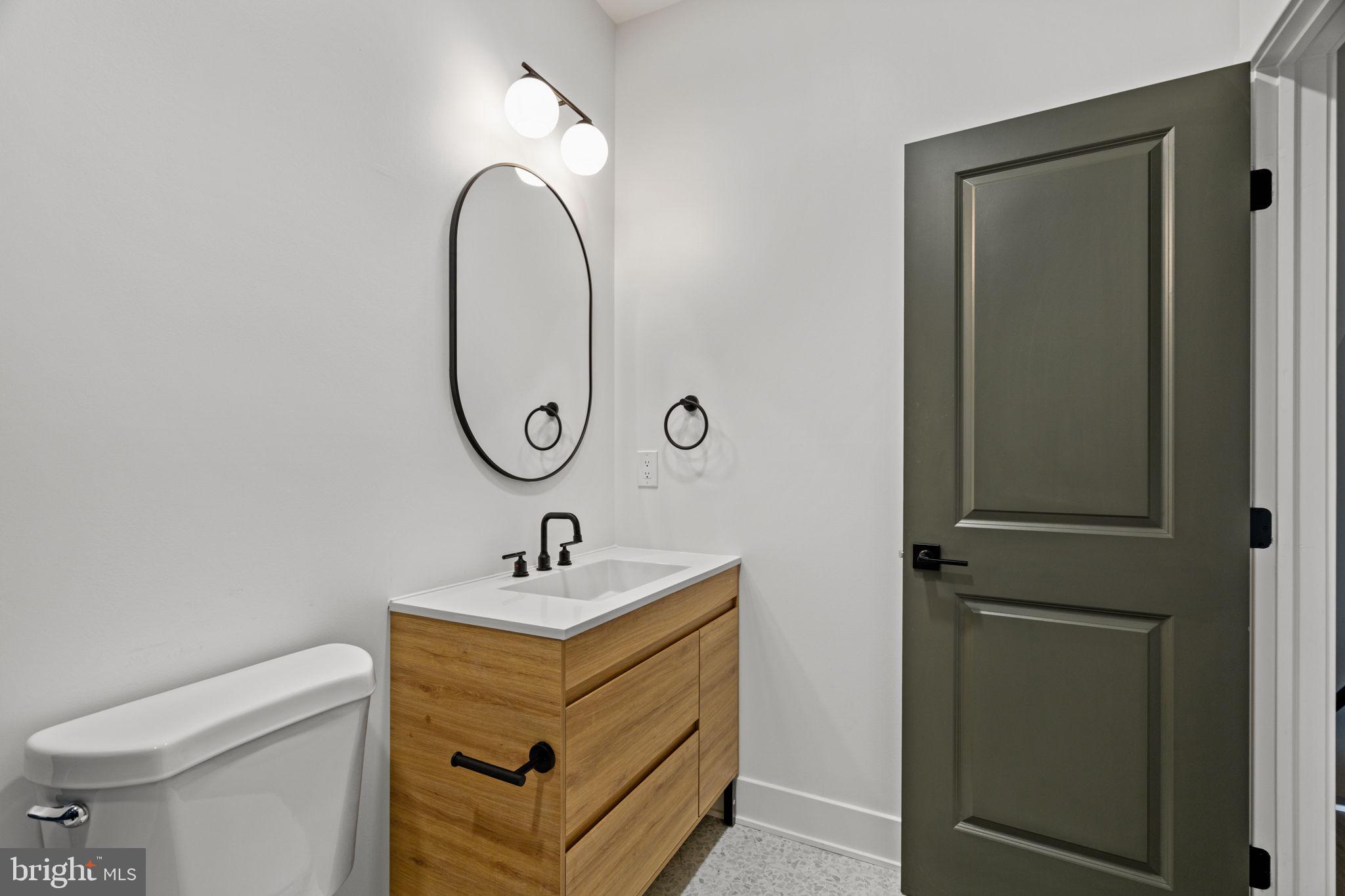 2410 Nicholas Street Philadelphia, PA 19121 - Photo 10 of 55 a bathroom with a sink and a mirror