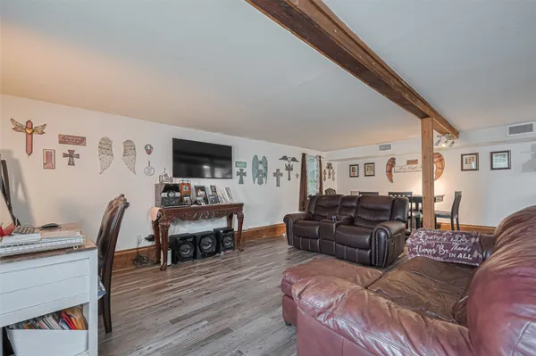 a living room with furniture flat screen tv and a fireplace