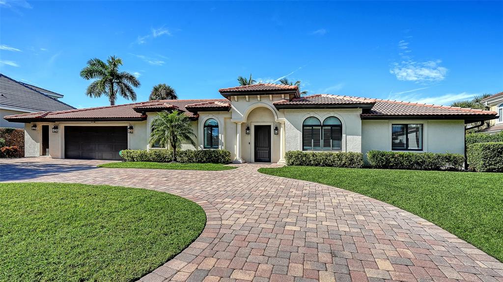 595 Bowsprit Lane Longboat Key, FL 34228 - Photo 1 of 49 a front view of a house with garden