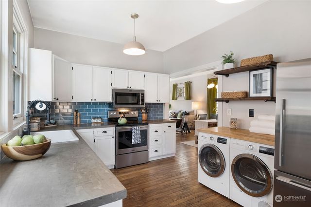 a view of a kitchen with stove and cabinets