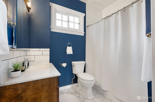 a white toilet sitting next to a white sink