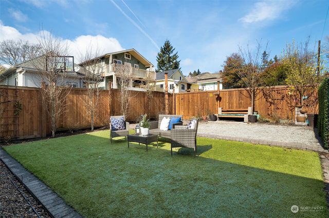 a view of a lake with table and chairs