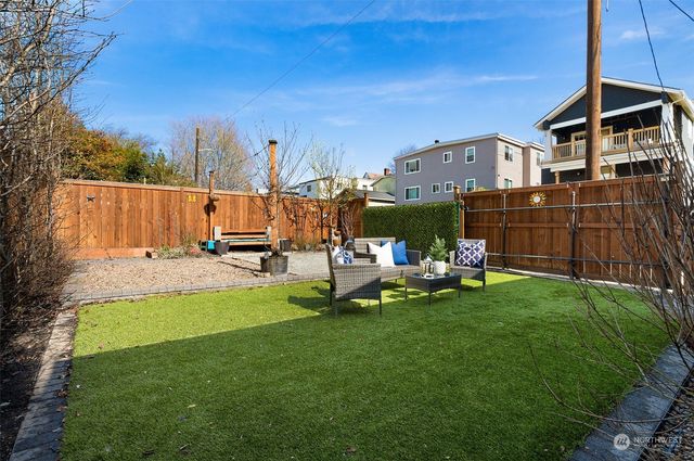 a view of a garden with sitting area
