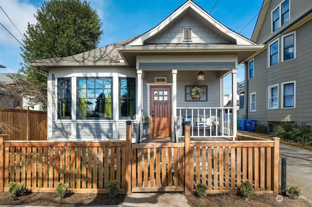 a view of a brick house with large windows and a table
