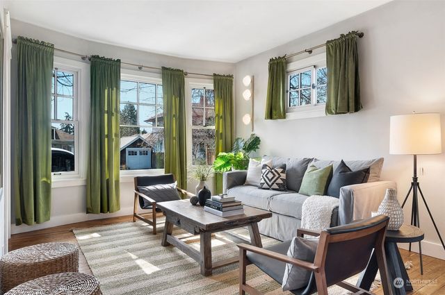 a living room with furniture and a painting on the wall