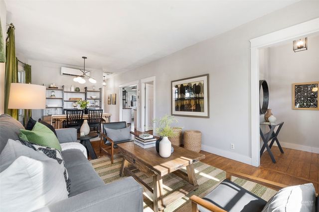 a living room with lots of furniture and a chandelier