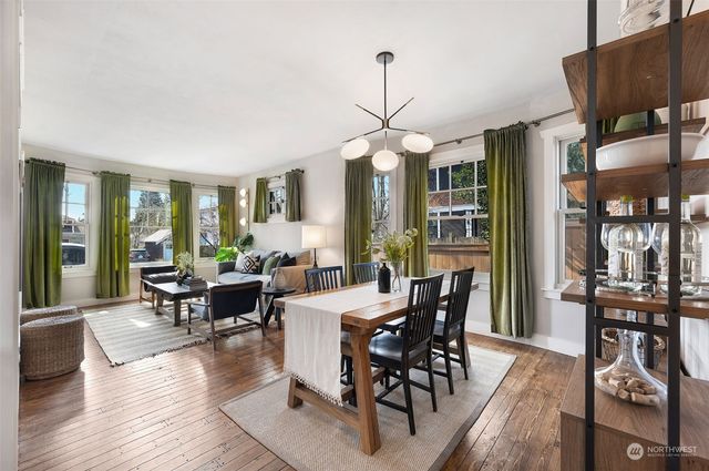 a view of a dining room with furniture window and wooden floor
