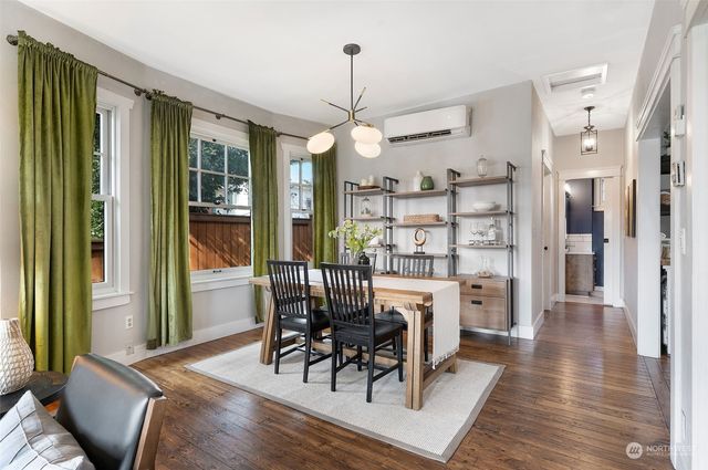 a view of a dining room with furniture window and wooden floor