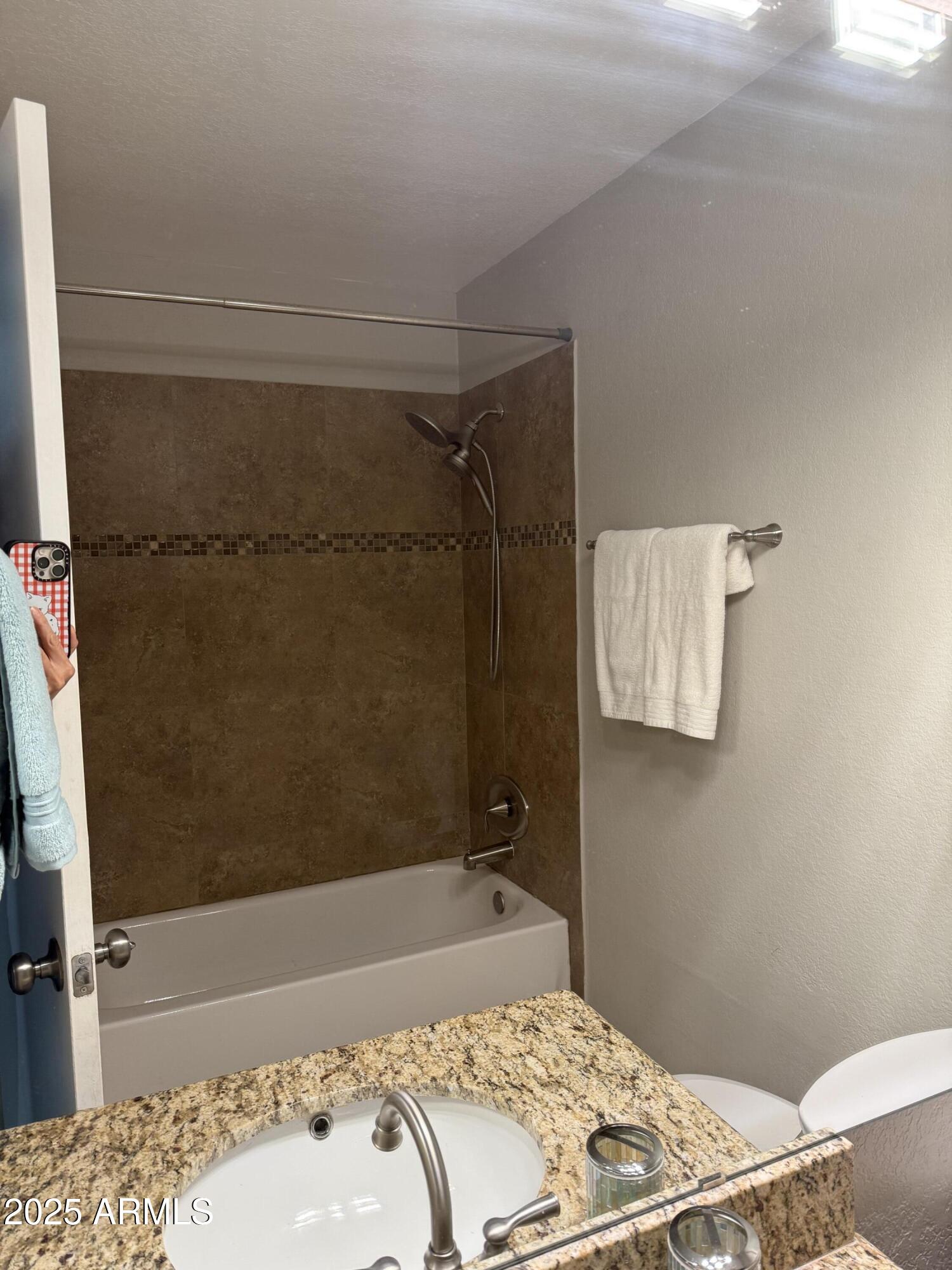 7977 West Wacker Road, Unit 249 Peoria, AZ 85381 - Photo 11 of 17 a bathroom with a bathtub and shower