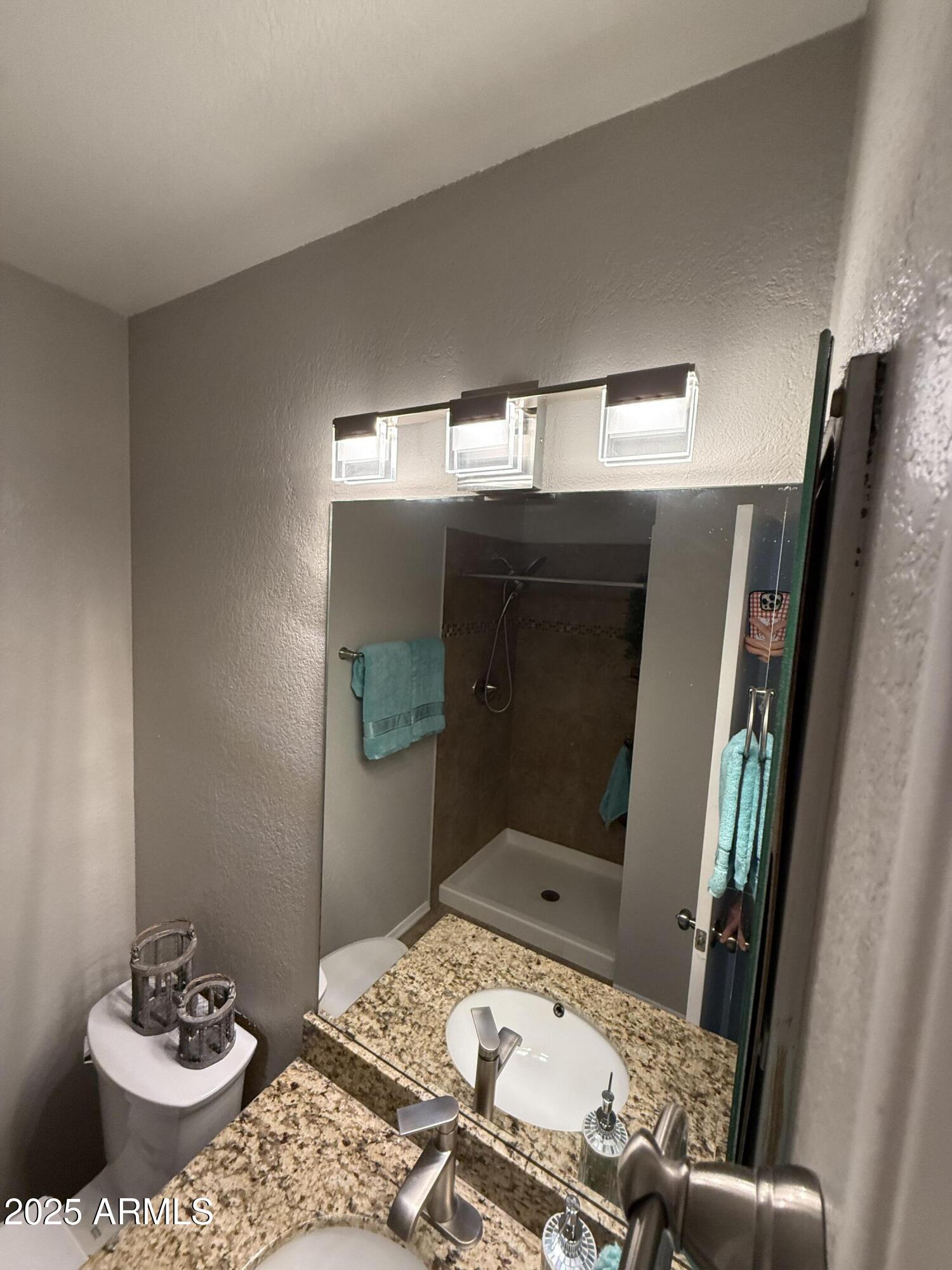 7977 West Wacker Road, Unit 249 Peoria, AZ 85381 - Photo 13 of 17 a bathroom with a sink and mirror