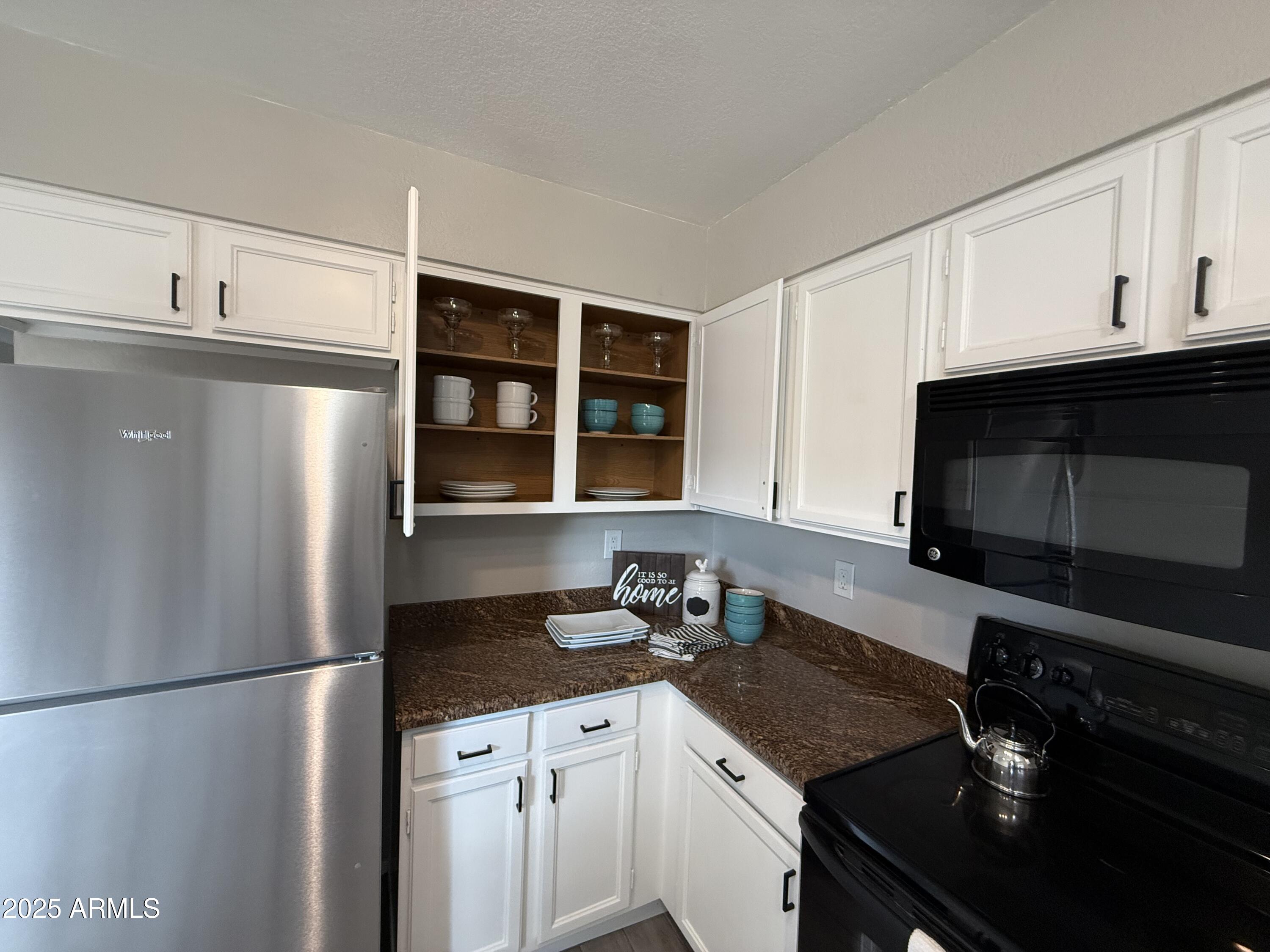 7977 West Wacker Road, Unit 249 Peoria, AZ 85381 - Photo 3 of 17 a kitchen with stainless steel appliances a refrigerator sink and microwave