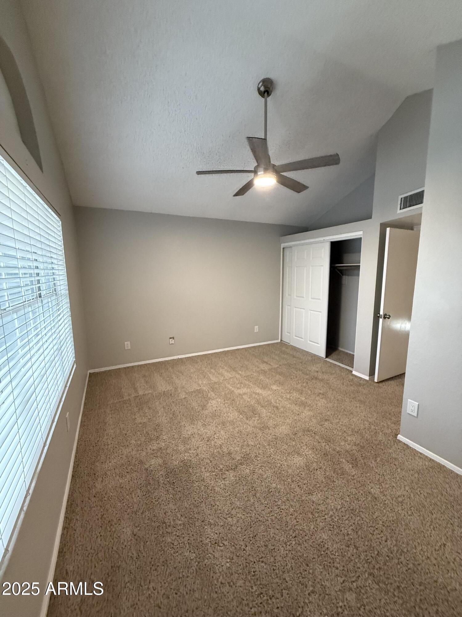 7977 West Wacker Road, Unit 249 Peoria, AZ 85381 - Photo 6 of 17 a view of an empty room with a window