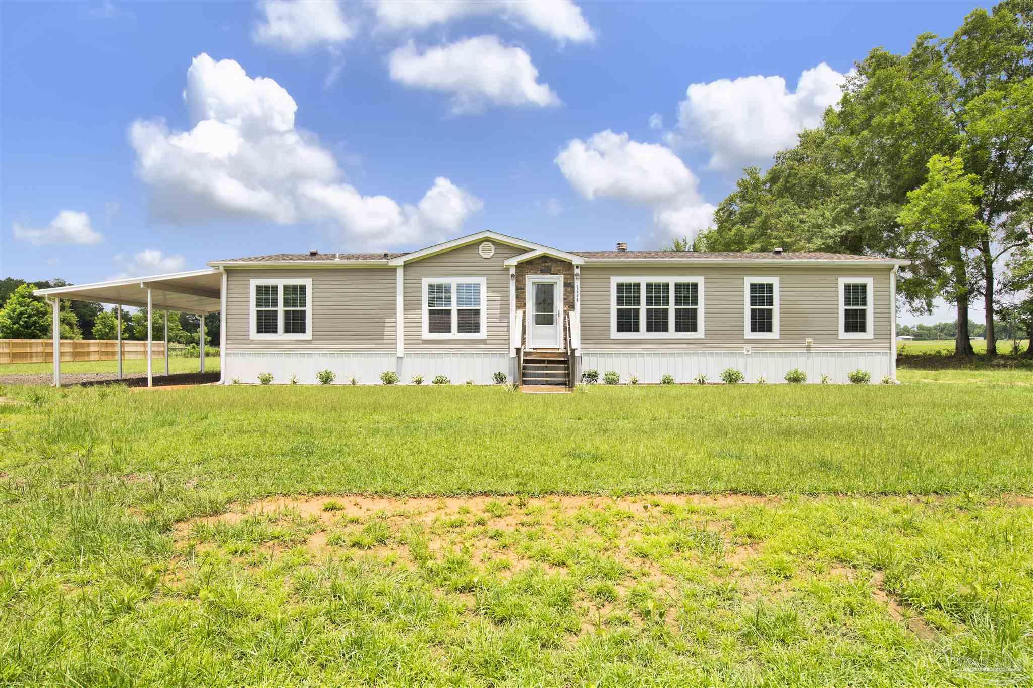 a front view of house with yard and green space
