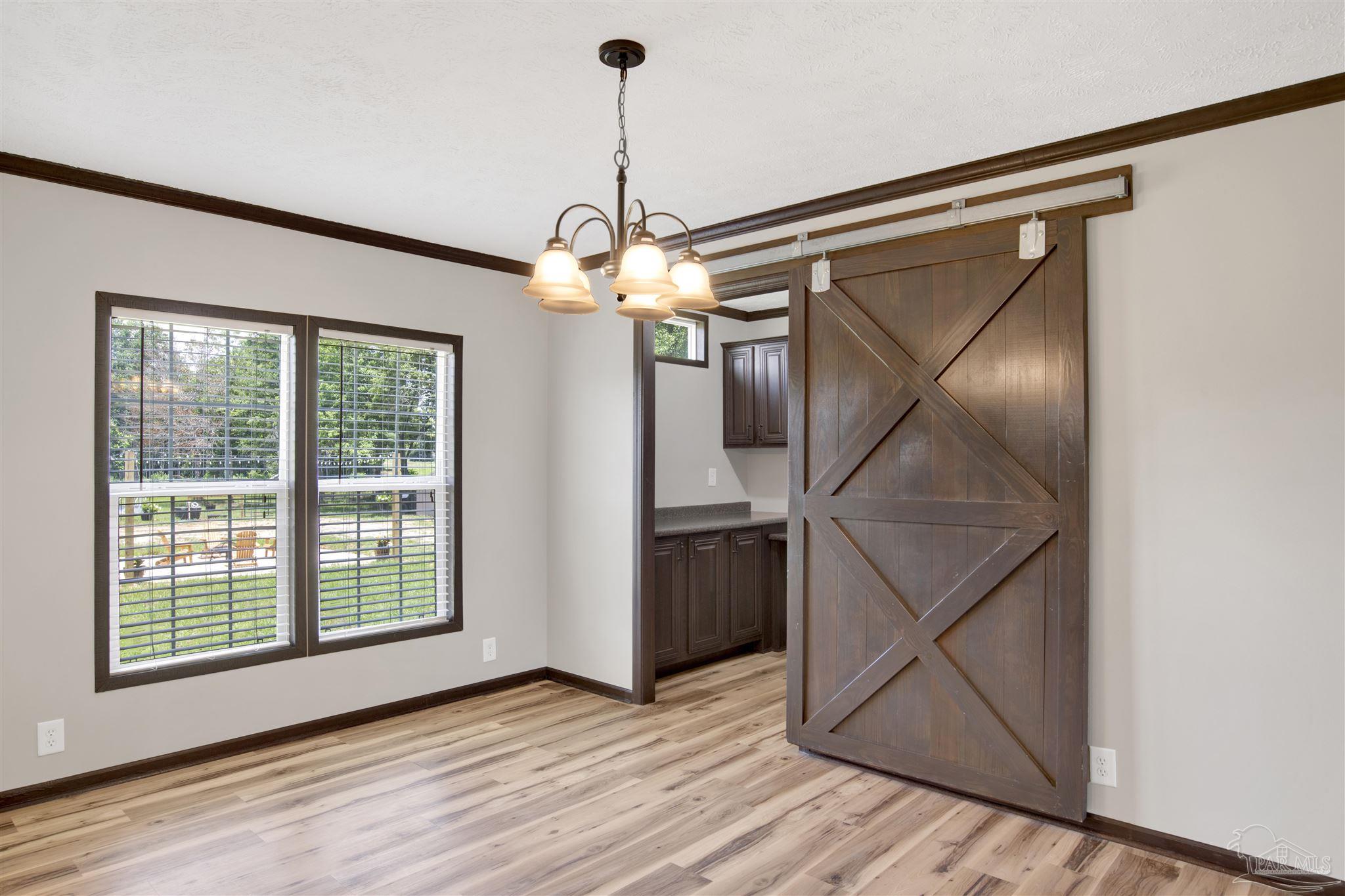 6594 Will Jones Road Jay, FL 32565 - Photo 14 of 39 a view of a livingroom with wooden floor and stairs