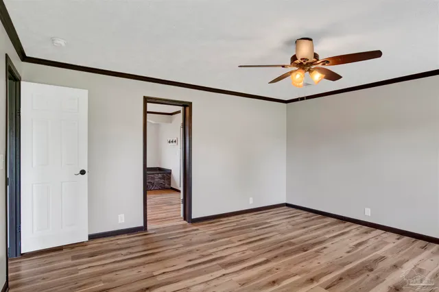 a view of empty room with wooden floor