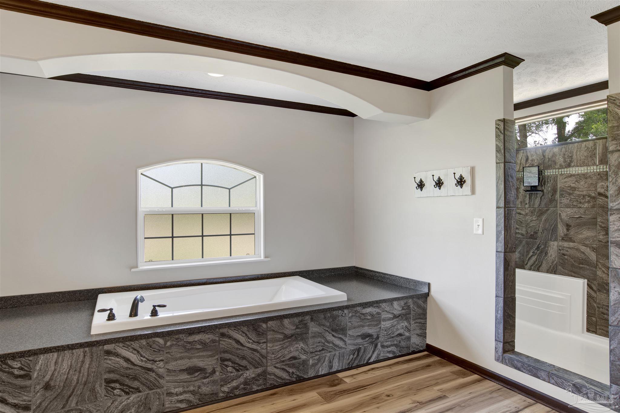 6594 Will Jones Road Jay, FL 32565 - Photo 21 of 39 a spacious bedroom with a bed and a window