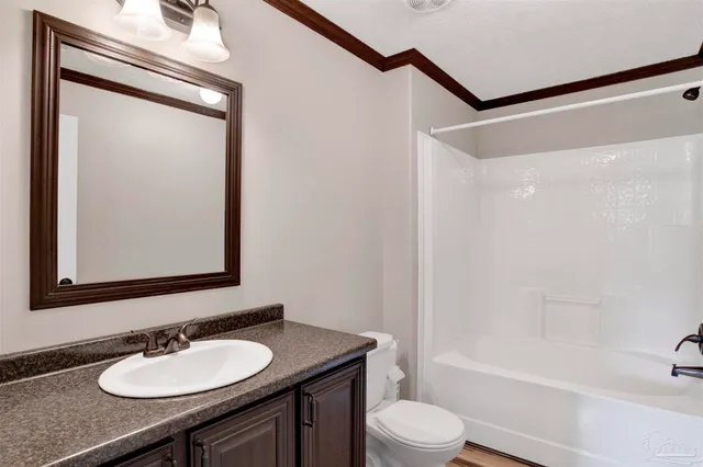 a bathroom with a granite countertop sink toilet a mirror and shower