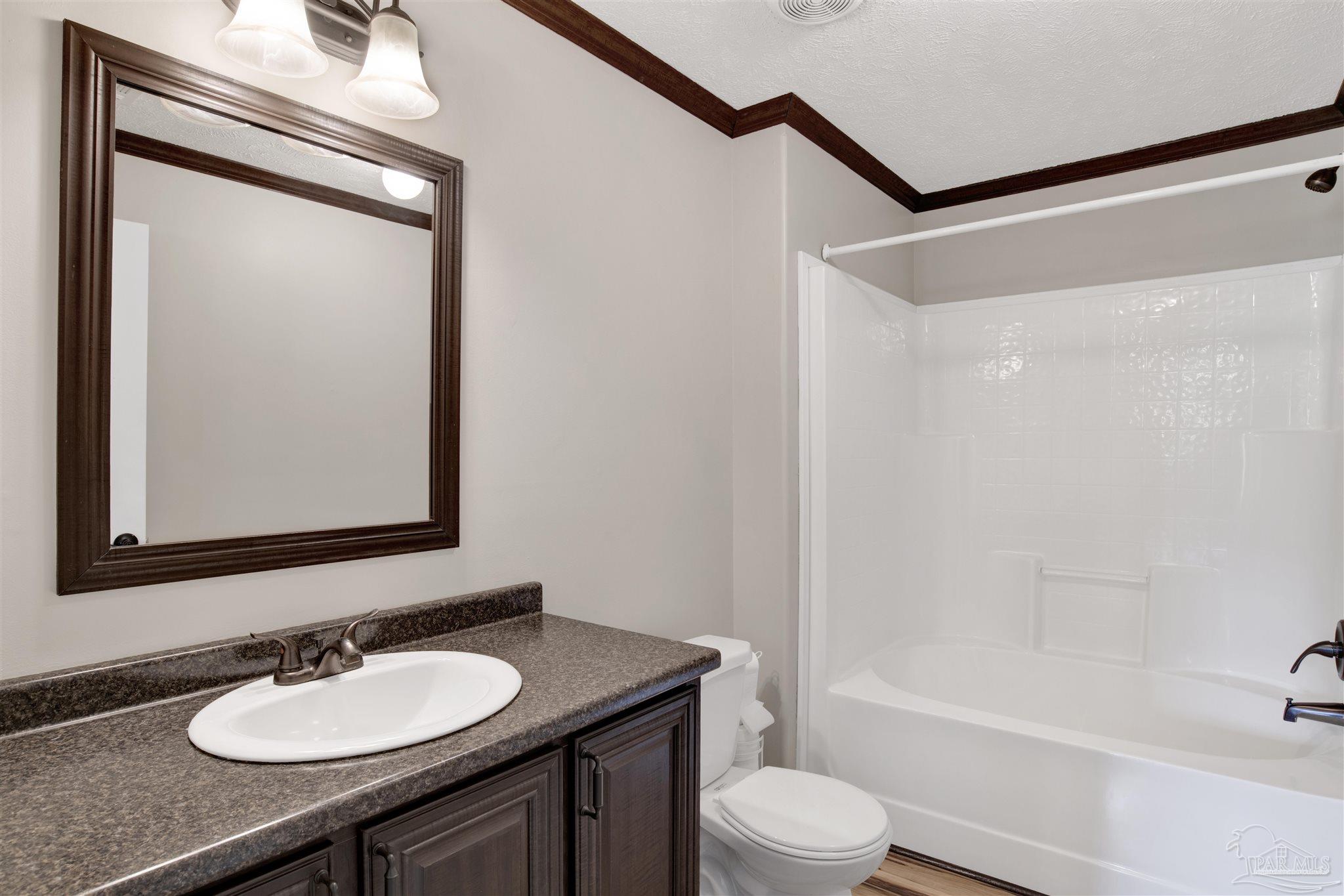 6594 Will Jones Road Jay, FL 32565 - Photo 25 of 39 a bathroom with a granite countertop sink toilet a mirror and shower