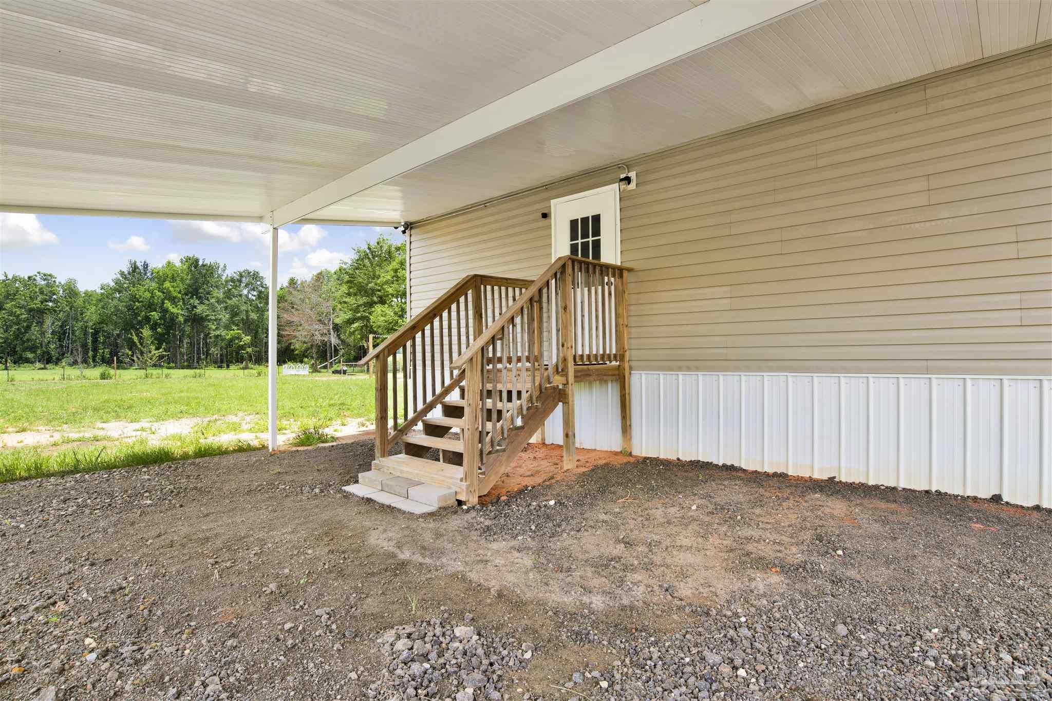 6594 Will Jones Road Jay, FL 32565 - Photo 27 of 39 a view of a garden with wooden fence