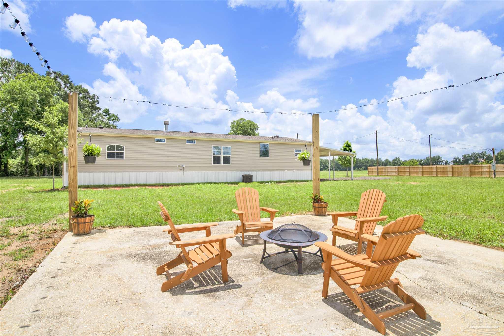 6594 Will Jones Road Jay, FL 32565 - Photo 28 of 39 a view of swimming pool and outdoor seating