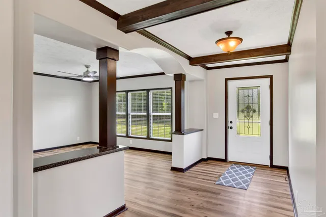 a view of an entryway with wooden floor