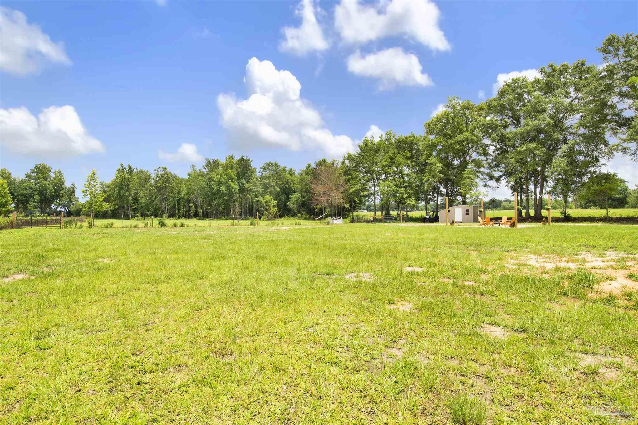 6594 Will Jones Road Jay, FL 32565 - Photo 31 of 39 a view of a swimming pool with an outdoor space and seating area