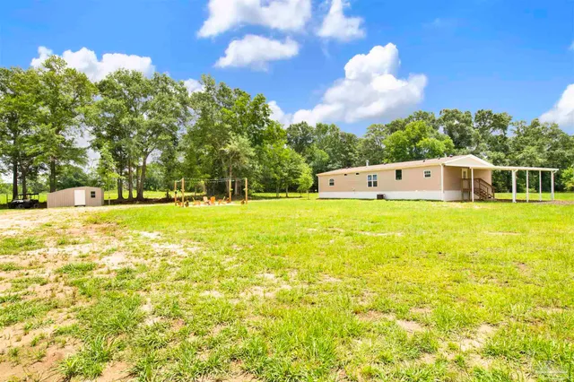 a view of a house with a big yard