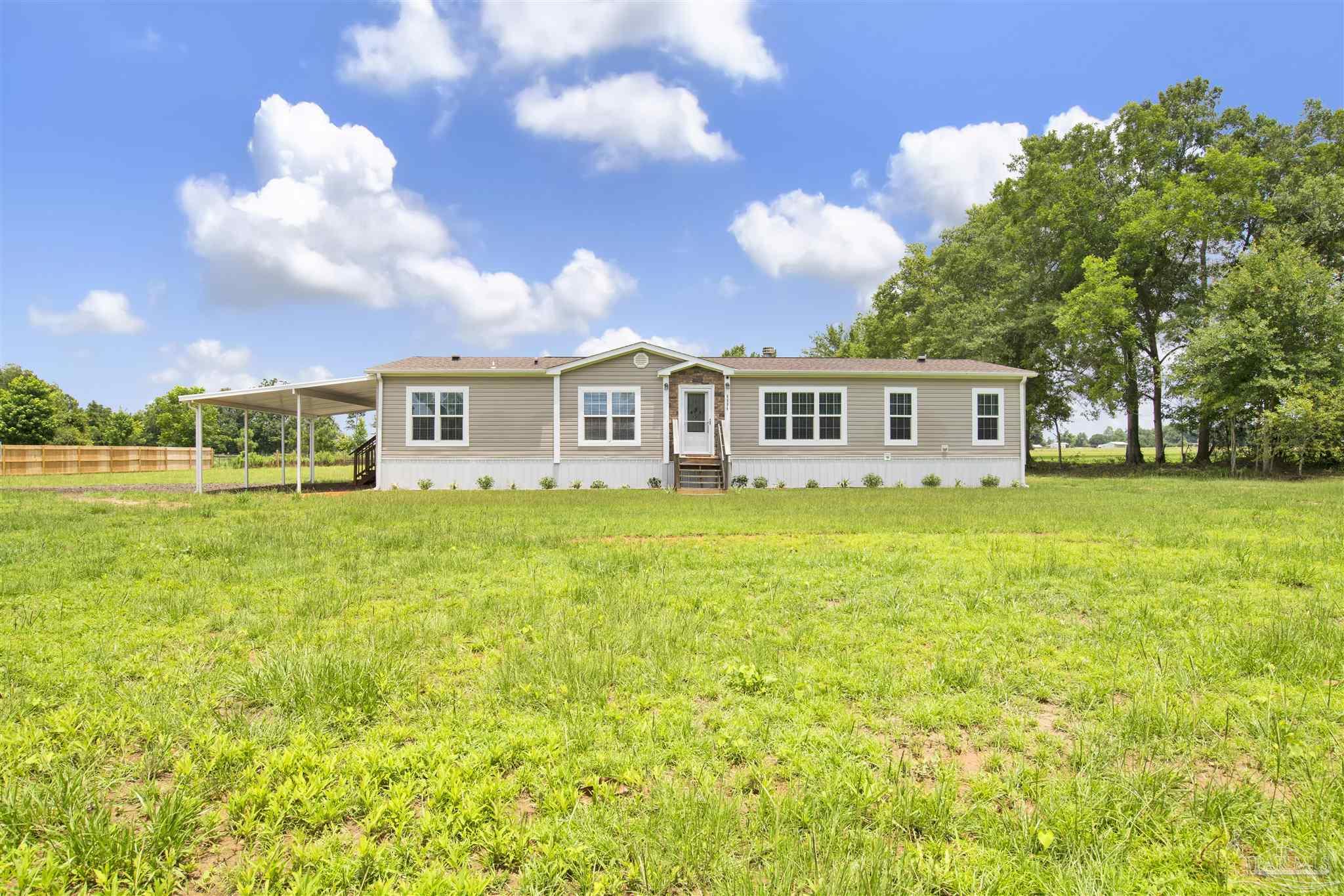6594 Will Jones Road Jay, FL 32565 - Photo 35 of 39 a view of a house with a big yard