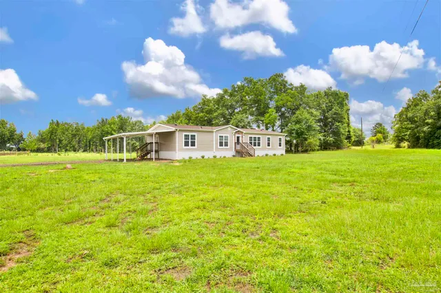 a view of a house with a big yard