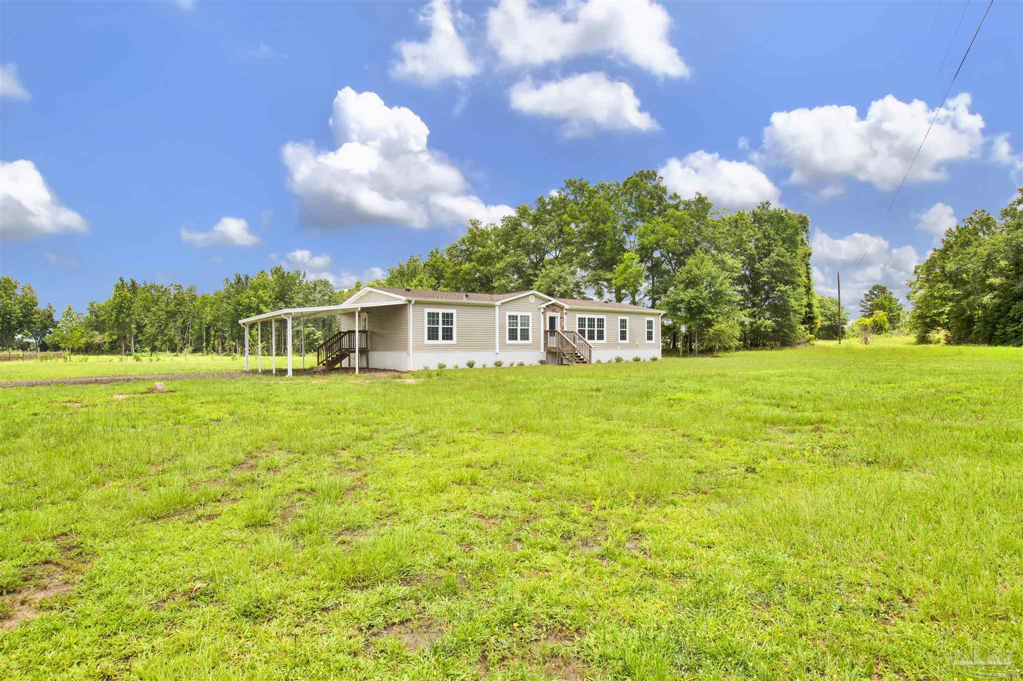 6594 Will Jones Road Jay, FL 32565 - Photo 38 of 39 a front view of a house with garden