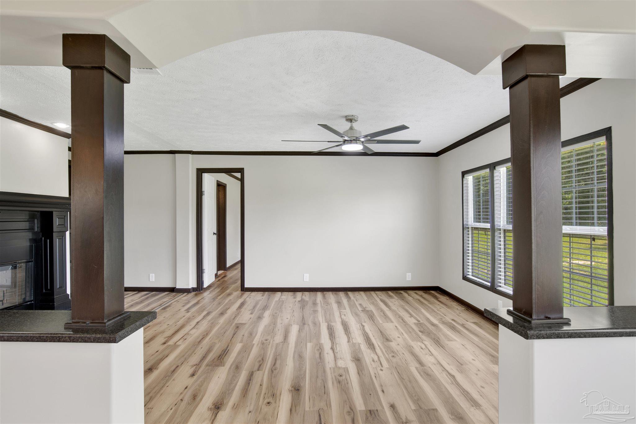 6594 Will Jones Road Jay, FL 32565 - Photo 4 of 39 a view of empty room with wooden floor and fan