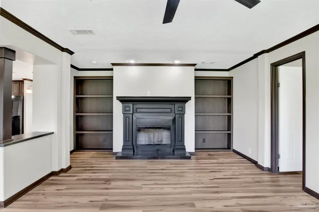 a view of a livingroom with a fireplace and window