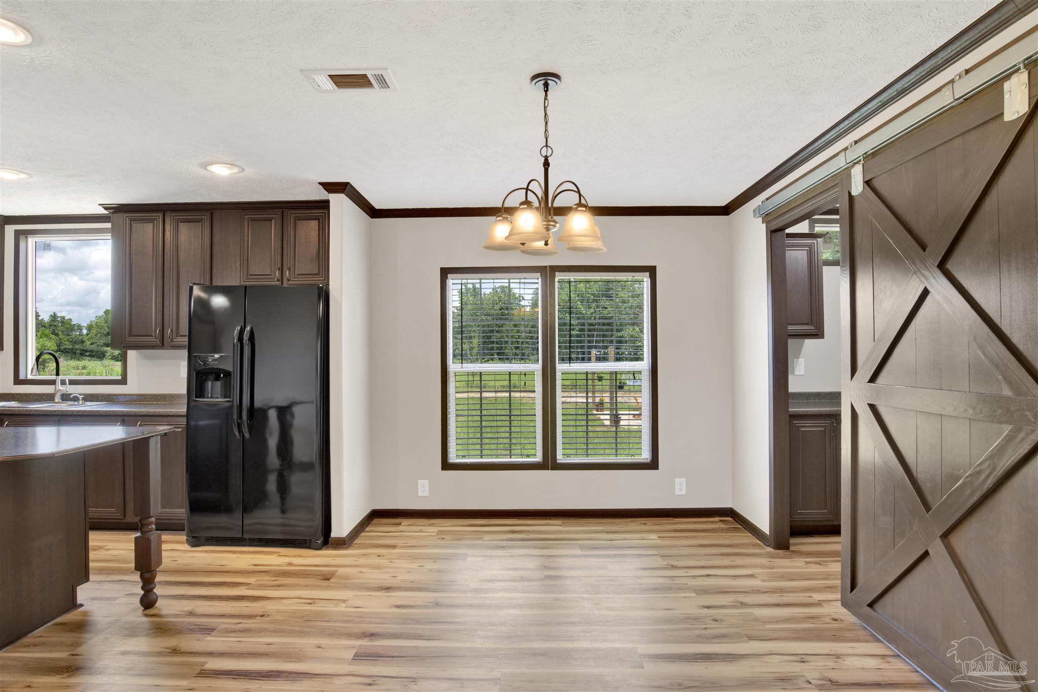 6594 Will Jones Road Jay, FL 32565 - Photo 9 of 39 a view of a kitchen with a sink and a window