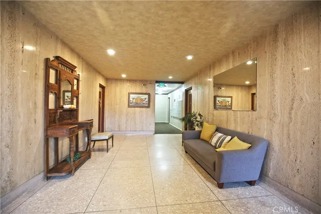 a lobby with furniture and large windows