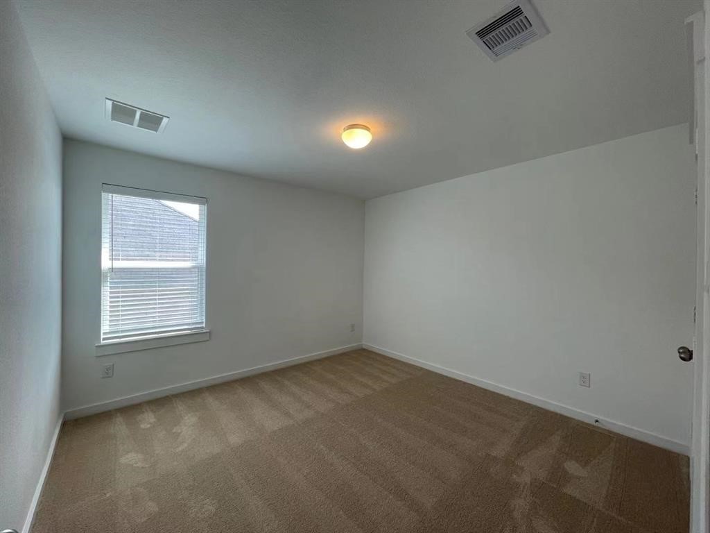 815 Summer Village Way Rosenberg, TX 77469 - Photo 17 of 21 an empty room with a window