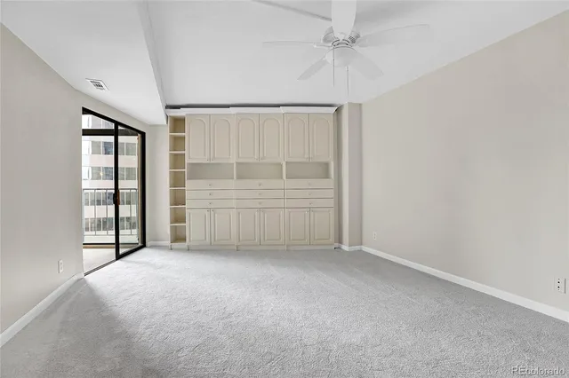 an empty room with windows and closet