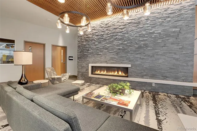 a living room with furniture and a lamp