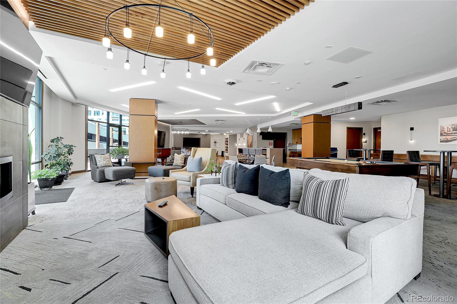 1777 Larimer Street, Unit 807 Denver, CO 80202 - Photo 22 of 25 a living room with lots of furniture and kitchen view