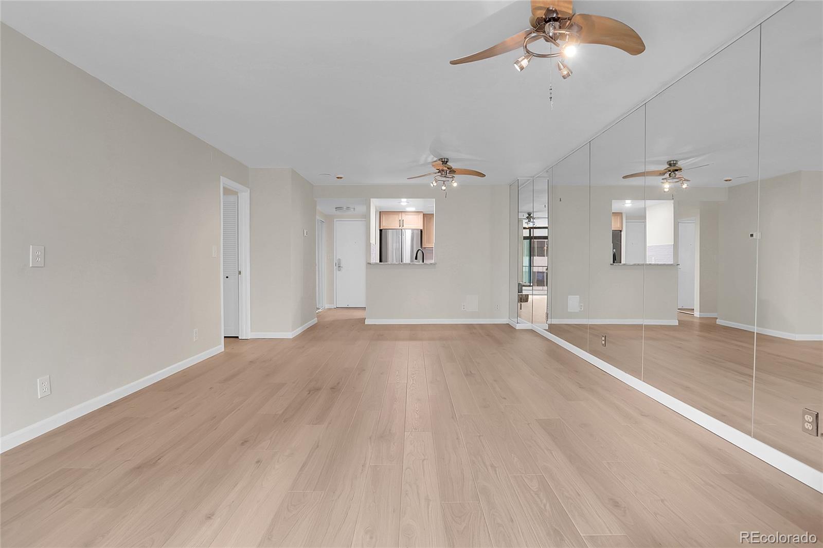 1777 Larimer Street, Unit 807 Denver, CO 80202 - Photo 3 of 25 an empty room with wooden floor and windows