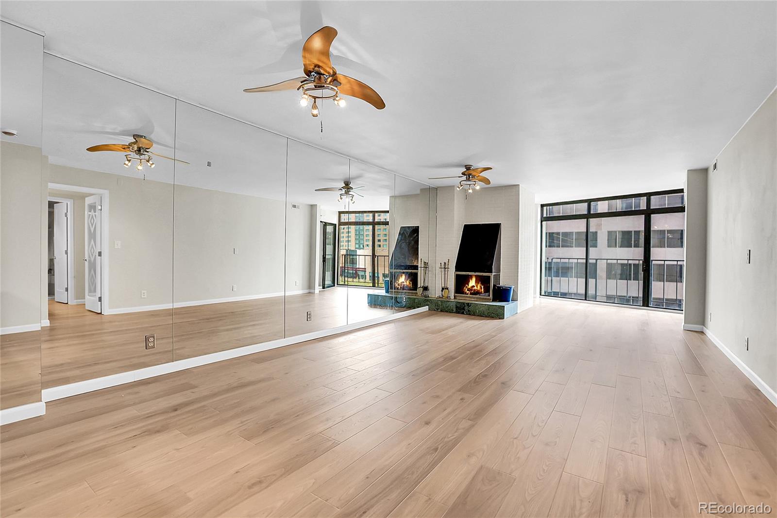 1777 Larimer Street, Unit 807 Denver, CO 80202 - Photo 4 of 25 a view of a livingroom with wooden floor and a fireplace
