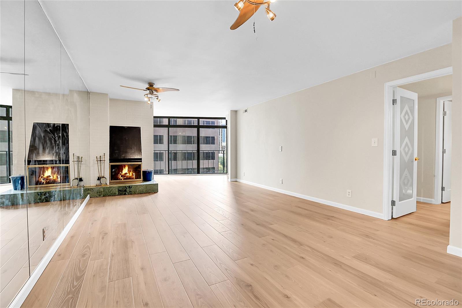1777 Larimer Street, Unit 807 Denver, CO 80202 - Photo 5 of 25 an empty room with wooden floor and windows