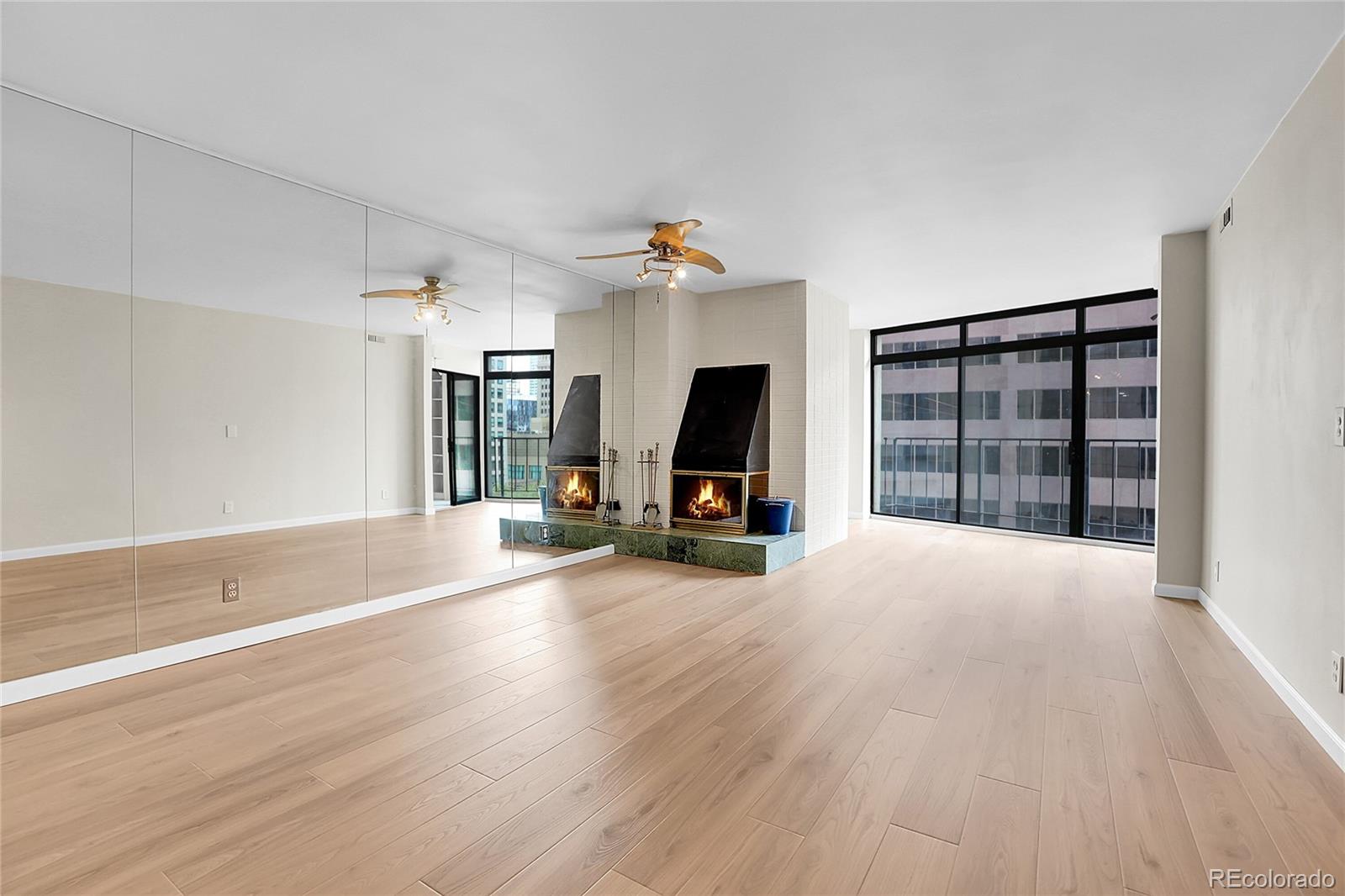 1777 Larimer Street, Unit 807 Denver, CO 80202 - Photo 6 of 25 a view of a big room with wooden floor staircase and windows
